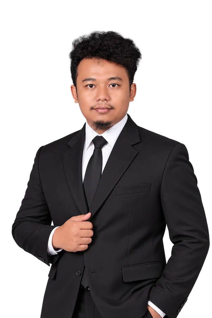 Portrait of Revianto in a black suit, one hand on the lapel